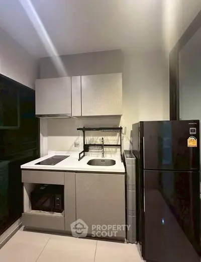 Modern compact kitchen with sleek cabinetry and appliances, ideal for urban living.