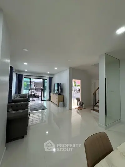 Spacious modern living room with sleek design and large windows for natural light.