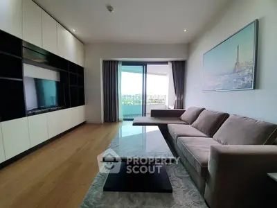 Spacious living room with modern decor and balcony view in a luxury apartment.