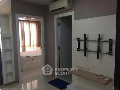 Modern apartment interior with wall-mounted TV bracket and air conditioning.