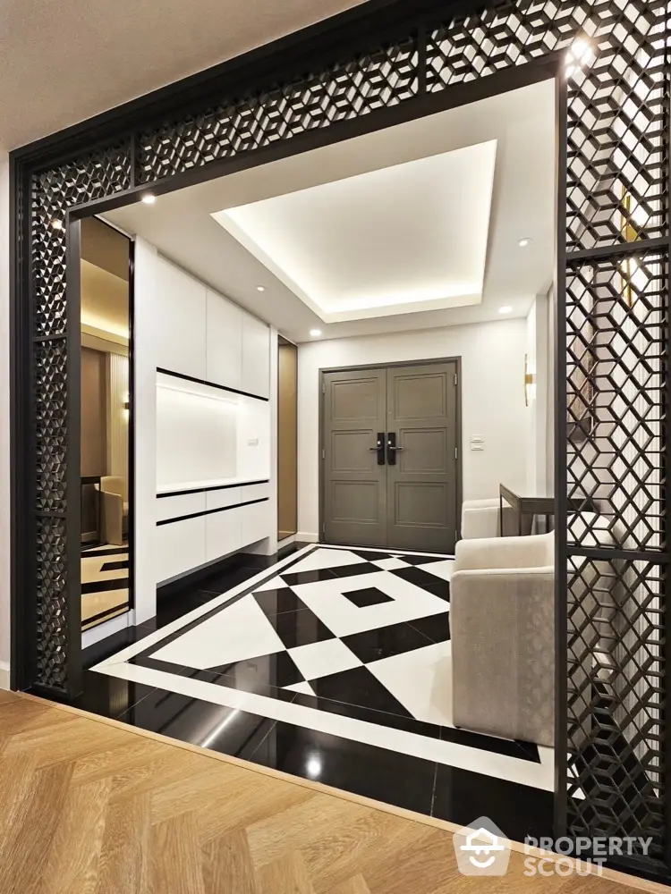 Elegant modern entrance with geometric floor design and stylish decor