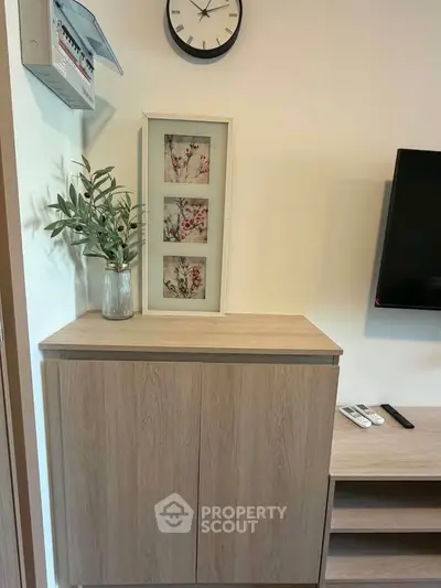 Modern living room with stylish wooden cabinet and wall-mounted TV, perfect for contemporary homes.