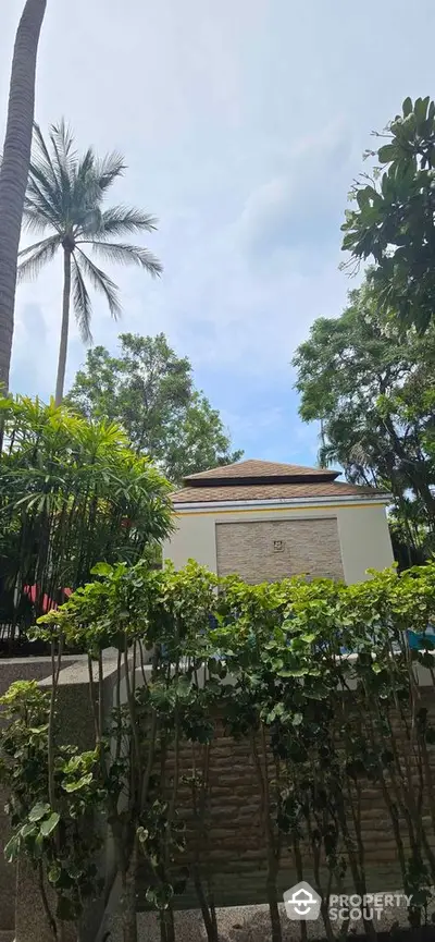 Tropical garden view with lush greenery and modern building exterior