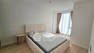 Spacious bedroom with natural light and modern furnishings