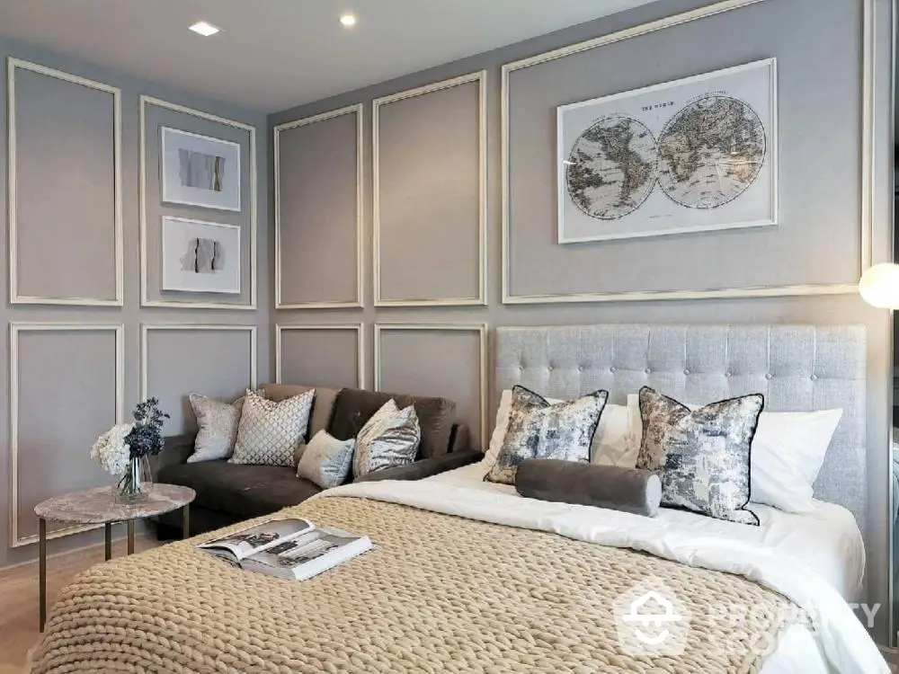 Luxurious bedroom with elegant decor and cozy seating area, perfect for relaxation.