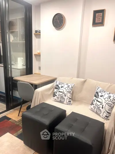 Cozy living room with modern decor and compact dining area, perfect for urban living.