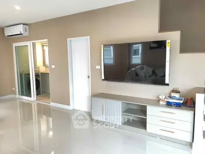 Modern living room with sleek TV setup and glossy tiled floors