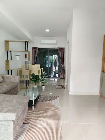 Spacious modern living room with elegant decor and glass coffee table