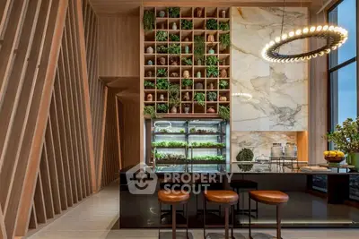 Luxurious modern kitchen with marble accents and vertical garden, featuring sleek black island and stylish lighting.