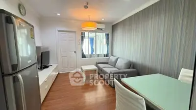 Modern living room with stylish decor, featuring a cozy sofa, sleek TV unit, and dining area, perfect for urban living.