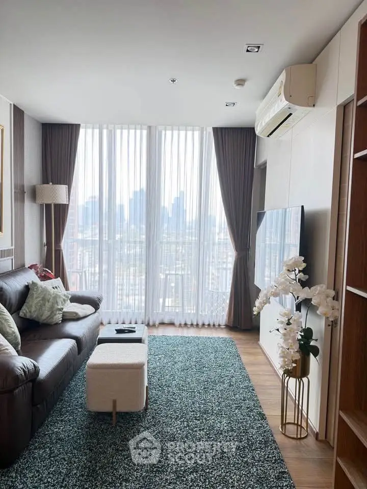 Modern living room with city view, featuring elegant decor and large windows.
