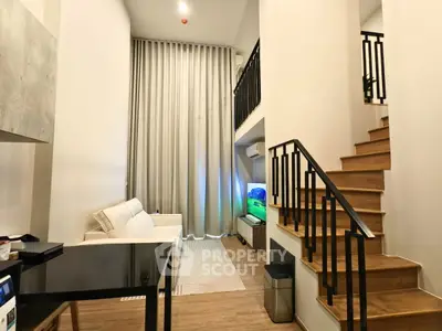 Modern duplex living room with high ceilings and stylish staircase