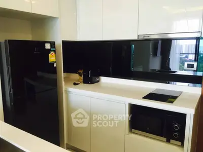 Modern kitchen with sleek black appliances and open layout