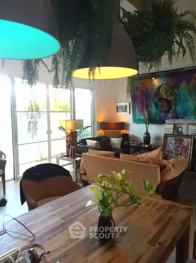 Chic living room with modern decor and vibrant lighting, perfect for stylish urban living.