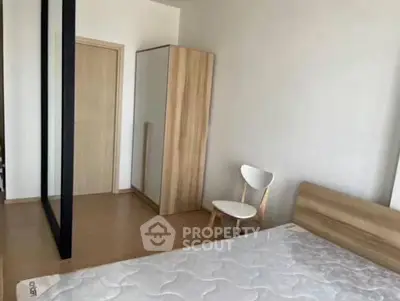 Modern minimalist bedroom with wooden furniture and natural light