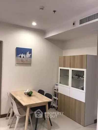 Modern dining area with sleek furniture and stylish decor in a contemporary apartment.