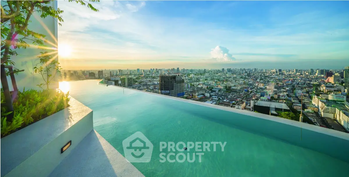 Stunning rooftop infinity pool with breathtaking city skyline view at sunset.