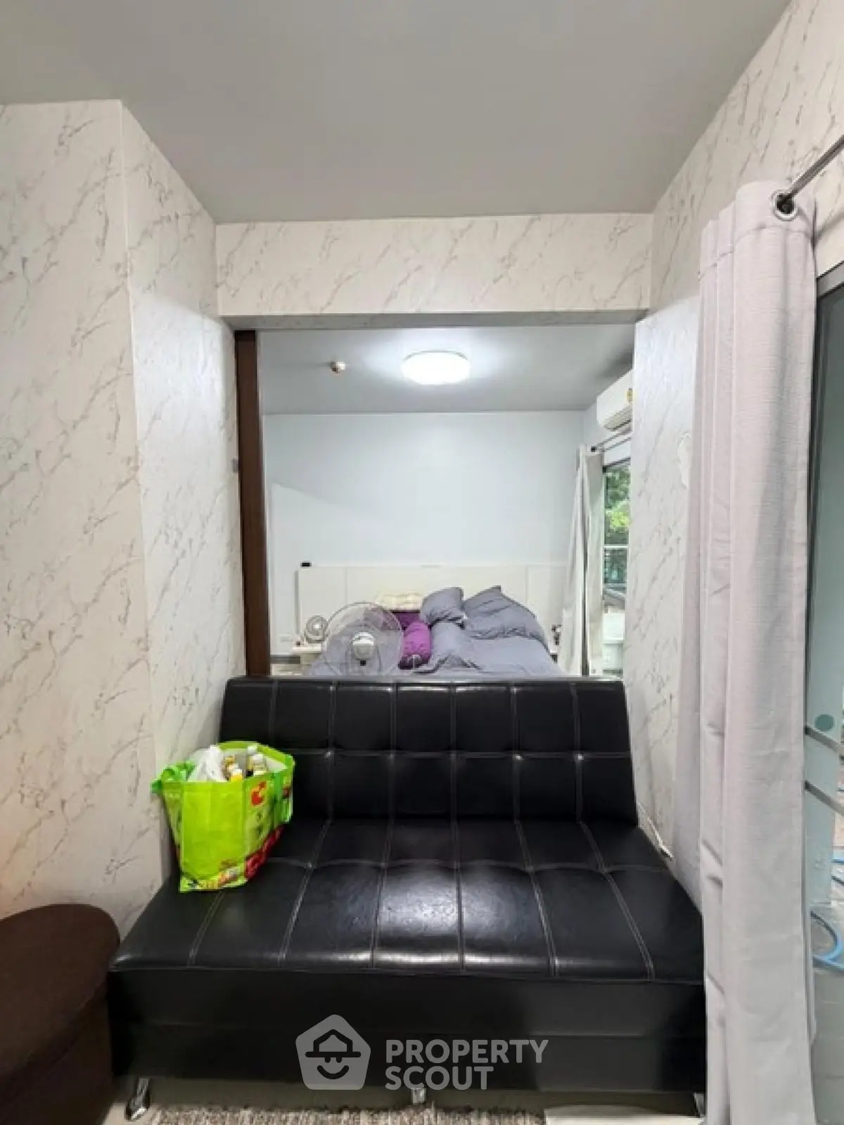 Cozy studio apartment with modern decor and comfortable seating area