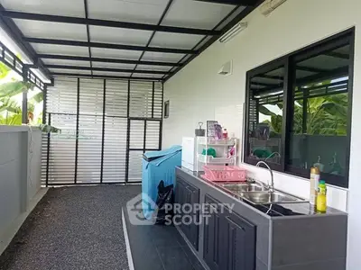Modern outdoor kitchen with sleek design and ample counter space, perfect for entertaining guests.