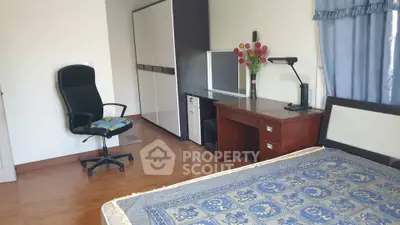 Spacious bedroom with modern furniture and large wardrobe