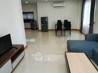 Spacious modern living room with sleek furniture and dining area