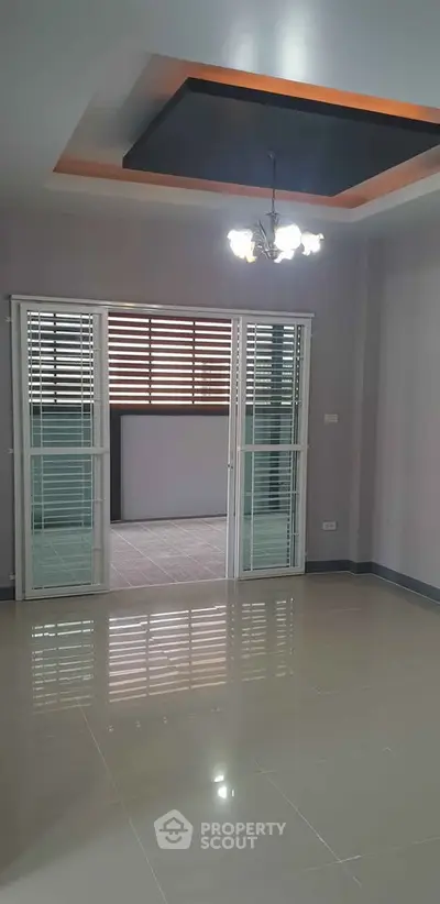 Spacious modern living room with elegant lighting and sliding doors