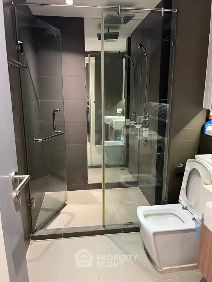 Modern bathroom with glass shower enclosure and sleek fixtures