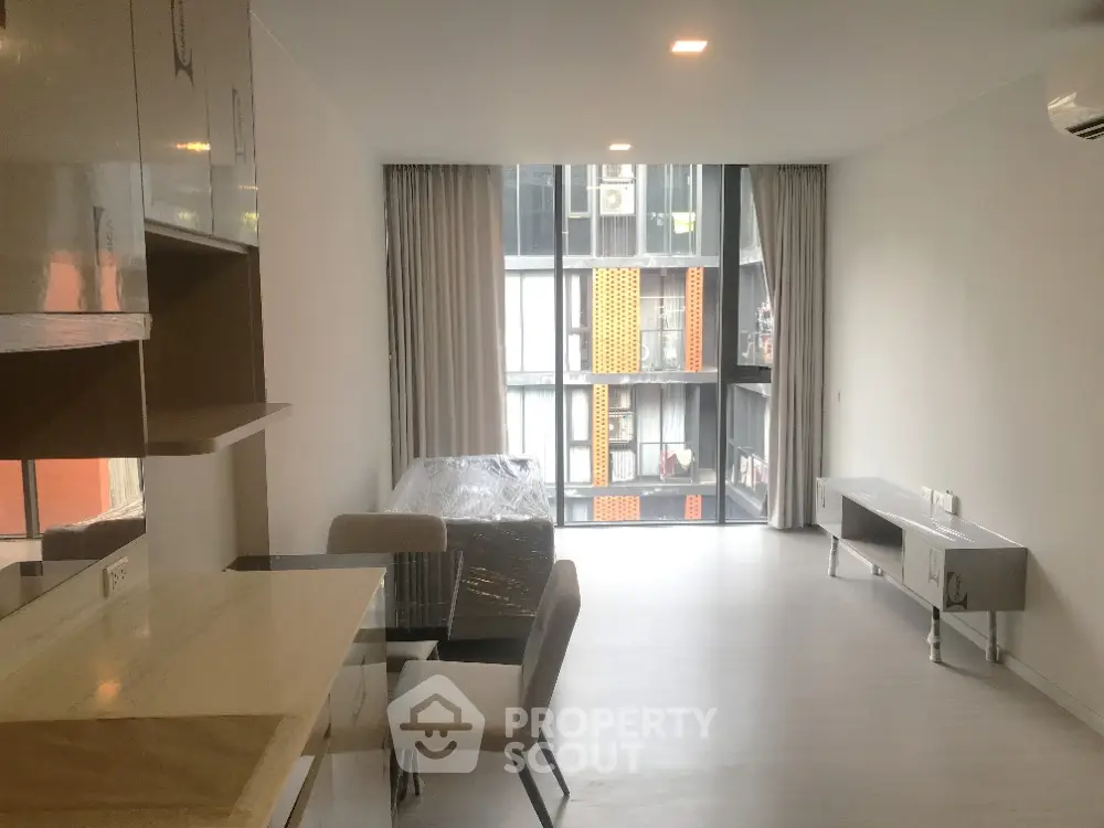 Modern living room with large windows and contemporary furniture in urban apartment