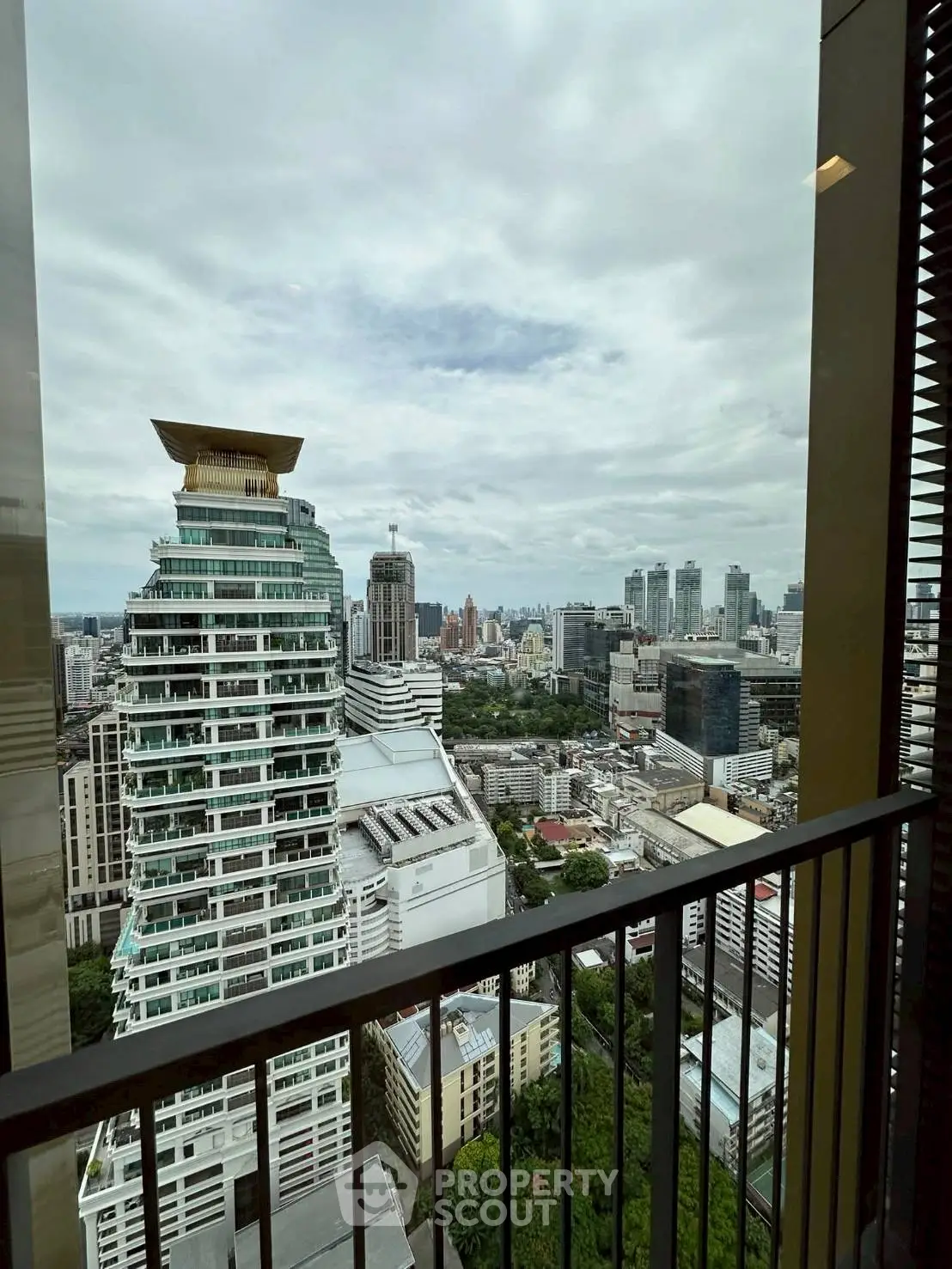 Stunning cityscape view from high-rise balcony with modern architecture.