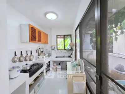 Bright and airy kitchen with open layout and modern appliances, featuring large windows and ample storage space.
