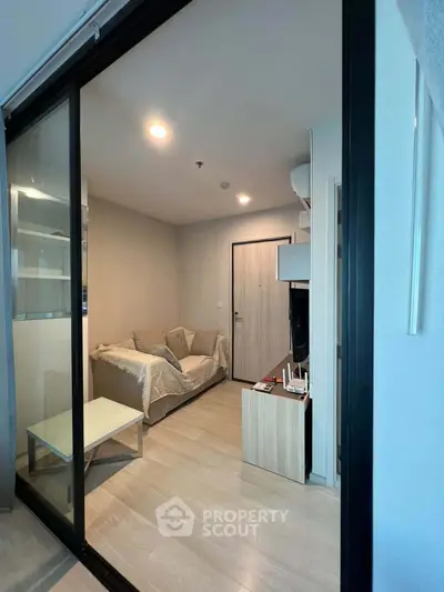 Modern living room with sleek design and cozy ambiance, featuring a comfortable sofa and stylish decor.
