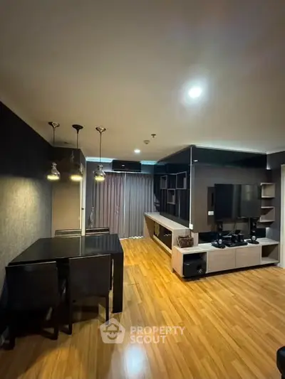 Modern living room with sleek furniture and wooden flooring, perfect for contemporary urban living.