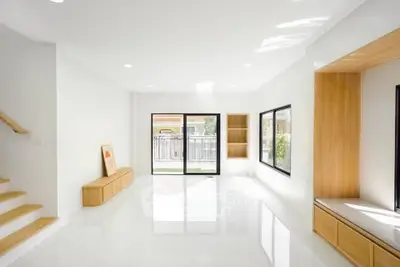 Spacious modern living room with large windows and natural light