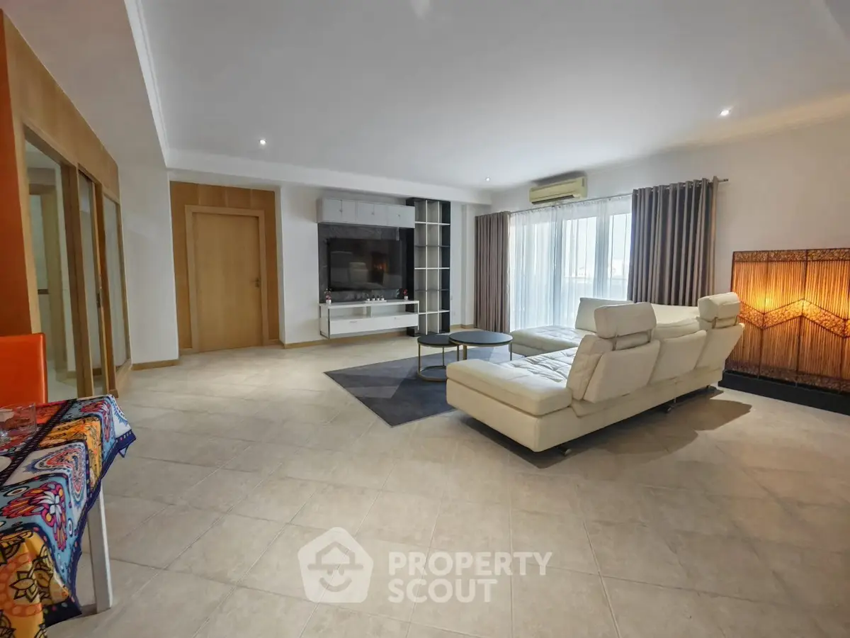 Spacious modern living room with elegant white sofa and large windows