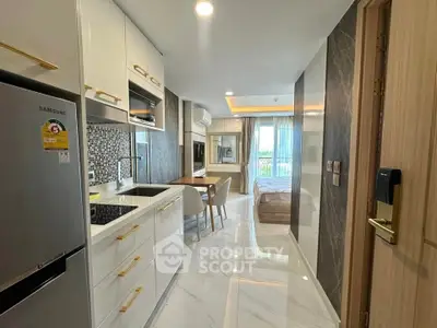 Modern open-layout kitchen and living area with sleek design and natural light