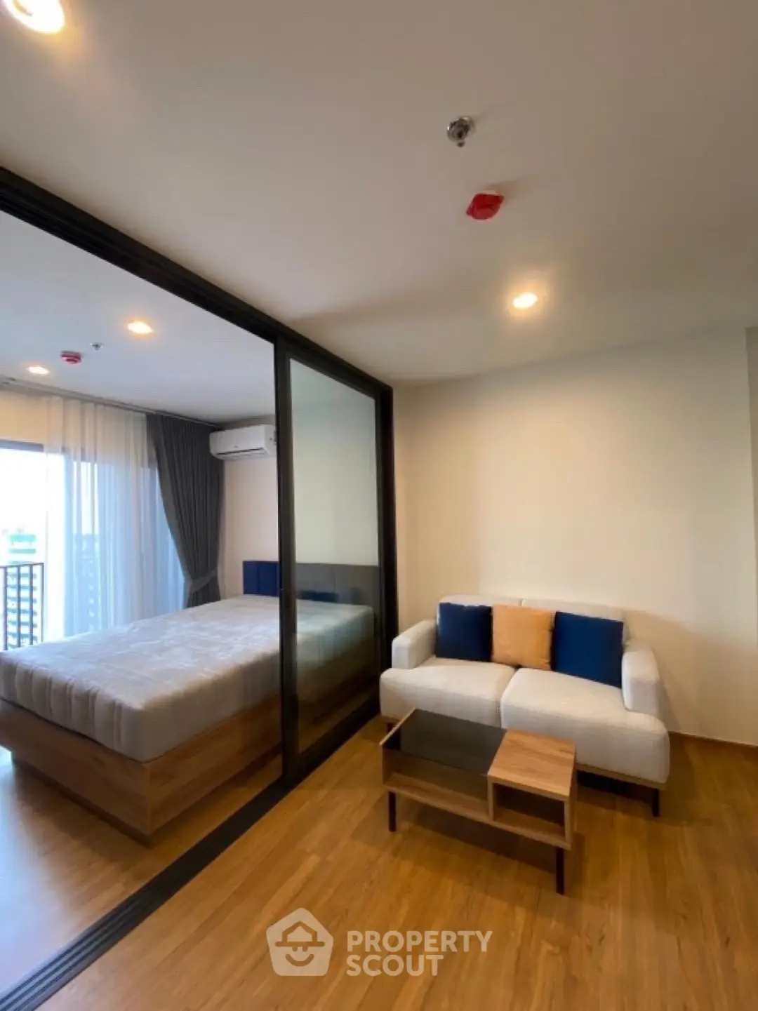 Modern studio apartment with glass partition and cozy furnishings