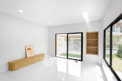 Bright and spacious living room with large windows and modern decor