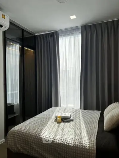 Cozy bedroom with modern decor and ample natural light