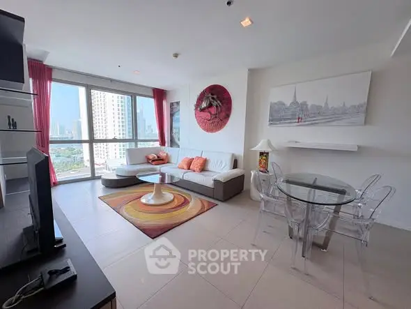Spacious modern living room with city view, stylish decor, and natural light in high-rise apartment.