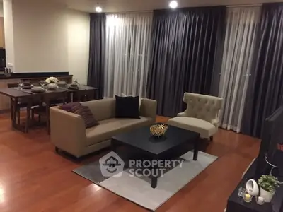 Elegant living room with modern furniture and dining area, perfect for entertaining guests.