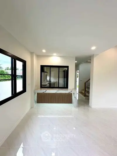 Spacious modern interior with large windows and sleek flooring, perfect for contemporary living.