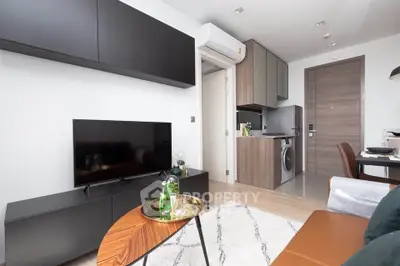 Modern living room with sleek furniture and integrated kitchen appliances in a stylish apartment.