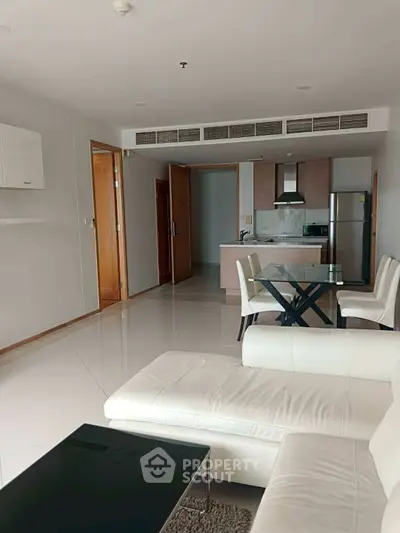 Spacious modern living room with open kitchen and sleek furniture