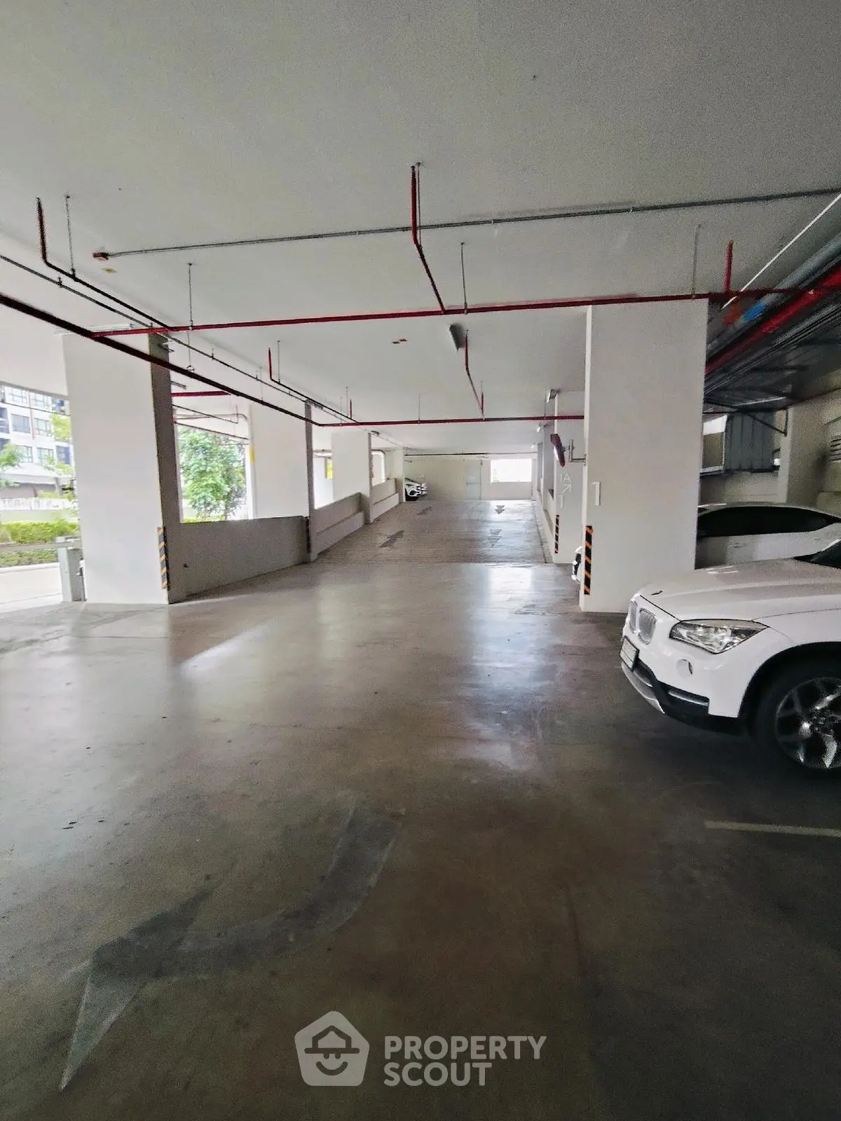 Spacious indoor parking area with ample lighting and easy access.