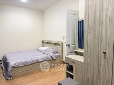 Cozy bedroom with wooden furniture and minimalist design, perfect for a serene living experience.