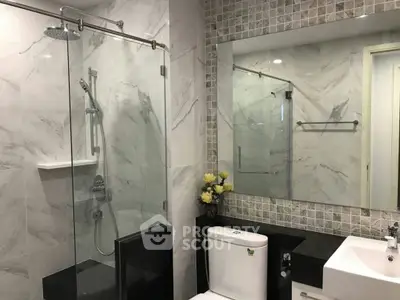 Modern bathroom with glass shower and elegant marble tiles