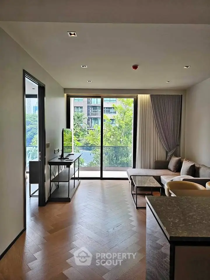 Spacious modern living room with large windows and balcony view in luxury apartment.