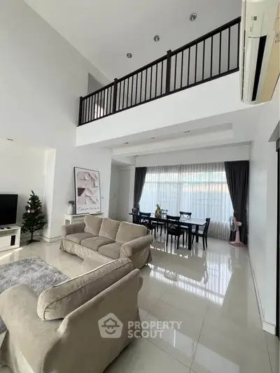 Spacious living room with high ceiling and elegant dining area in modern home