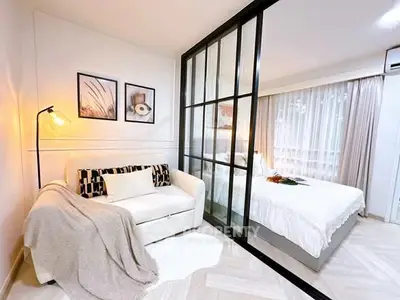 Modern studio apartment with glass partition and cozy decor