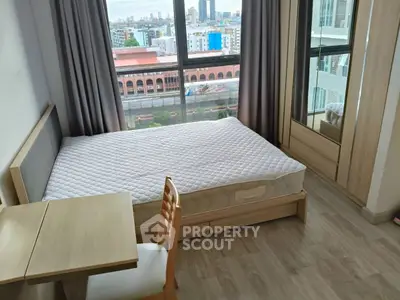 Modern bedroom with city view, featuring a cozy bed and wooden furniture.